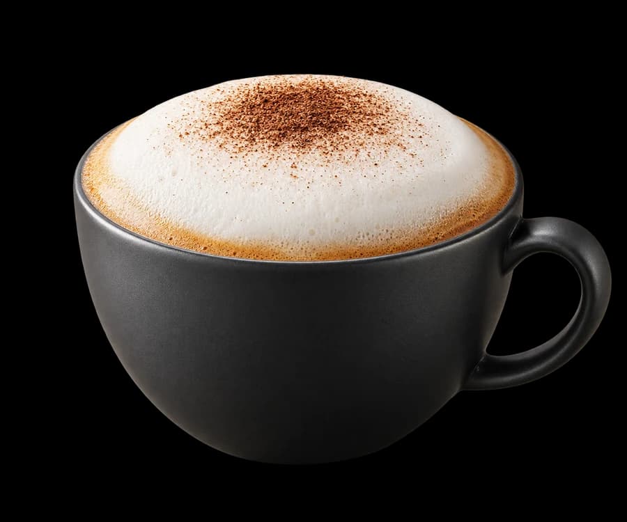 Cappuccino with a fine foam cap in a matte charcoal cup